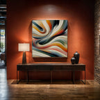 Modern interior with a colorful abstract painting on an orange wall, a console table, and decorative vases.