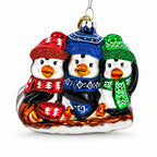Penguin Trio Sledding Glass Christmas Ornament