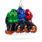 Penguin Trio Sledding Glass Christmas Ornament
